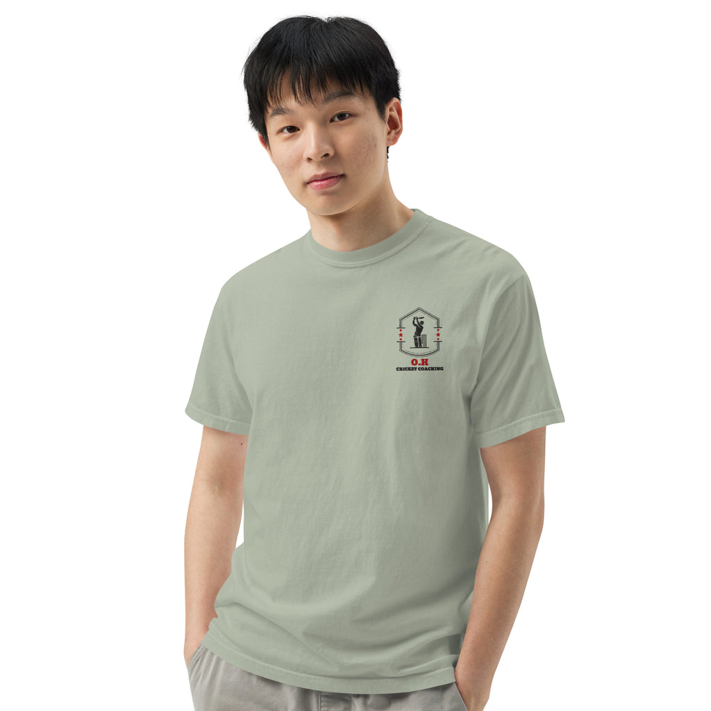 Person wearing a light green t-shirt with a logo on a white background