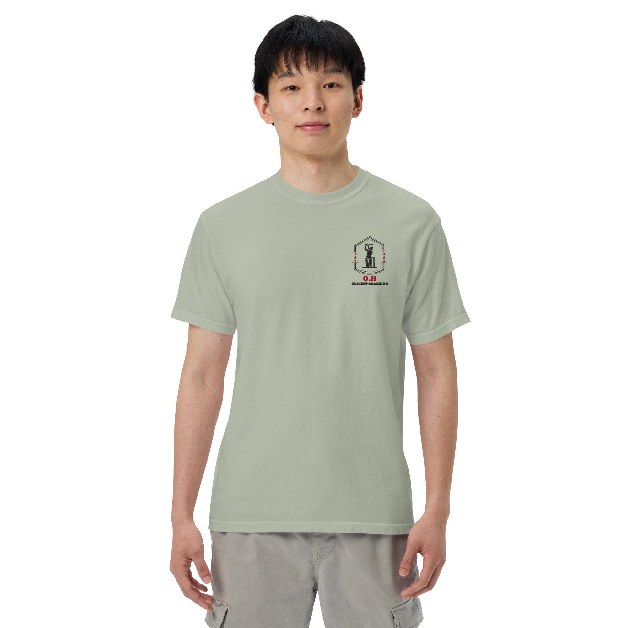 Person wearing a light green t-shirt with a black logo on a white background