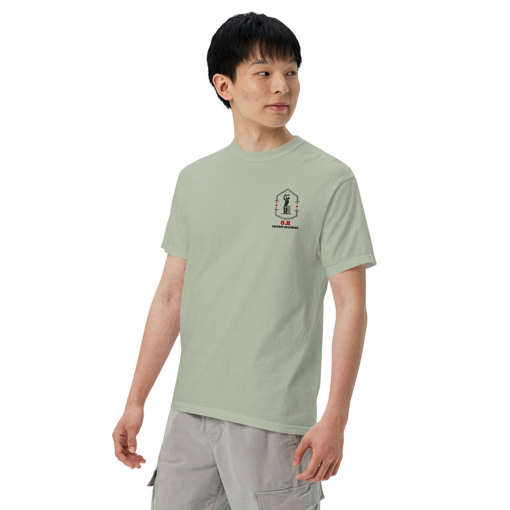 Person wearing a light green t-shirt with a small logo on a white background