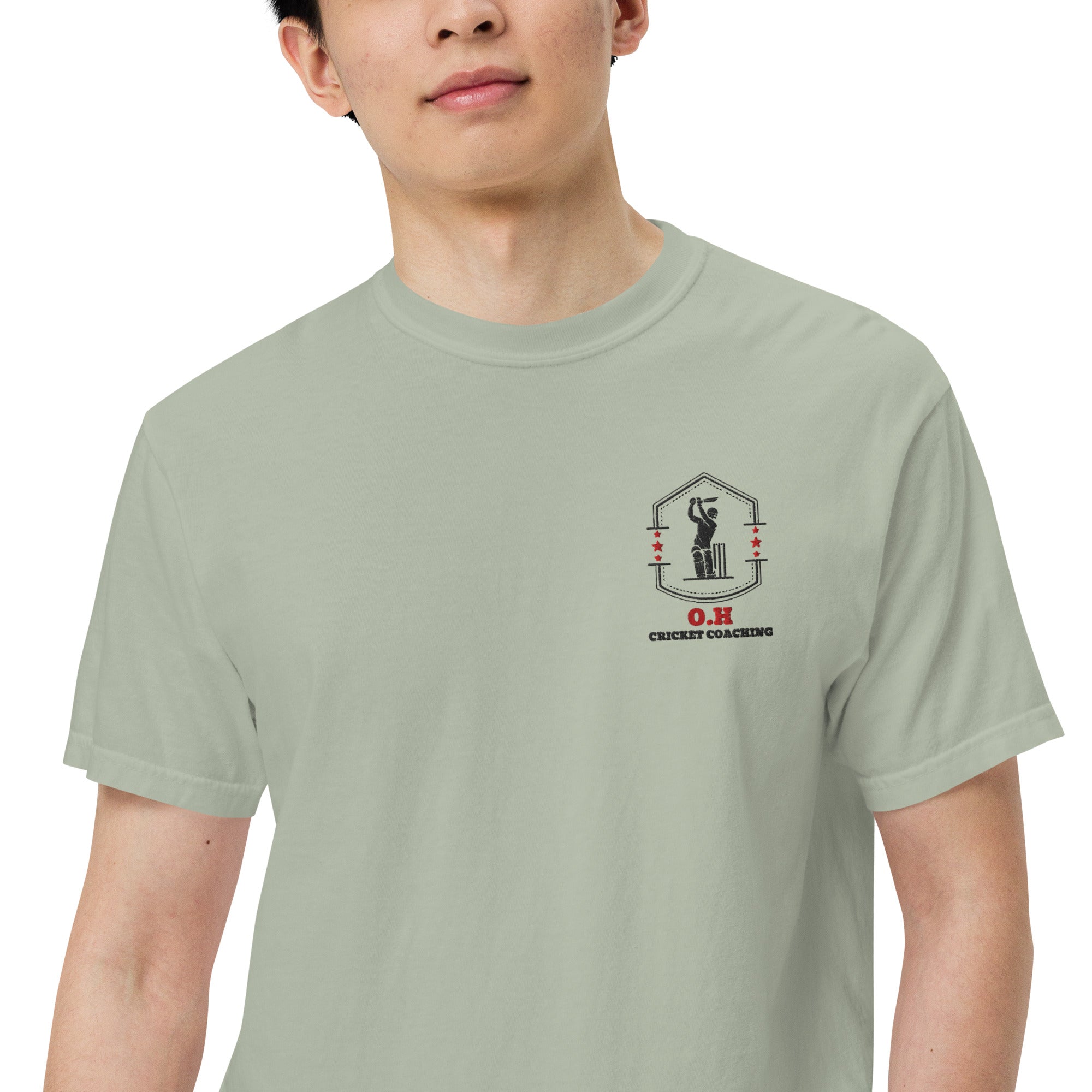 Person wearing a light green t-shirt with a logo and text on a white background