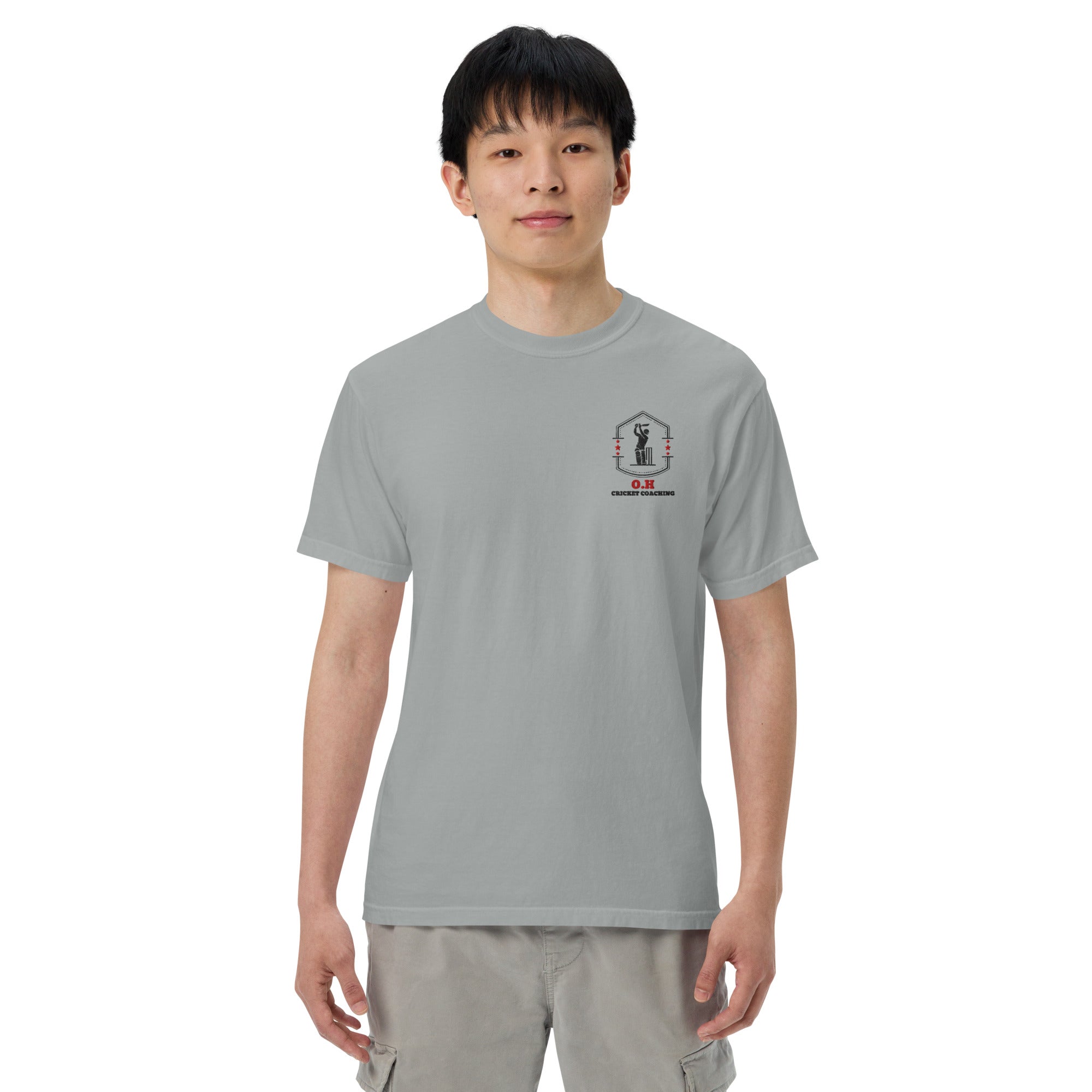 Person wearing a gray t-shirt with a graphic design on a white background