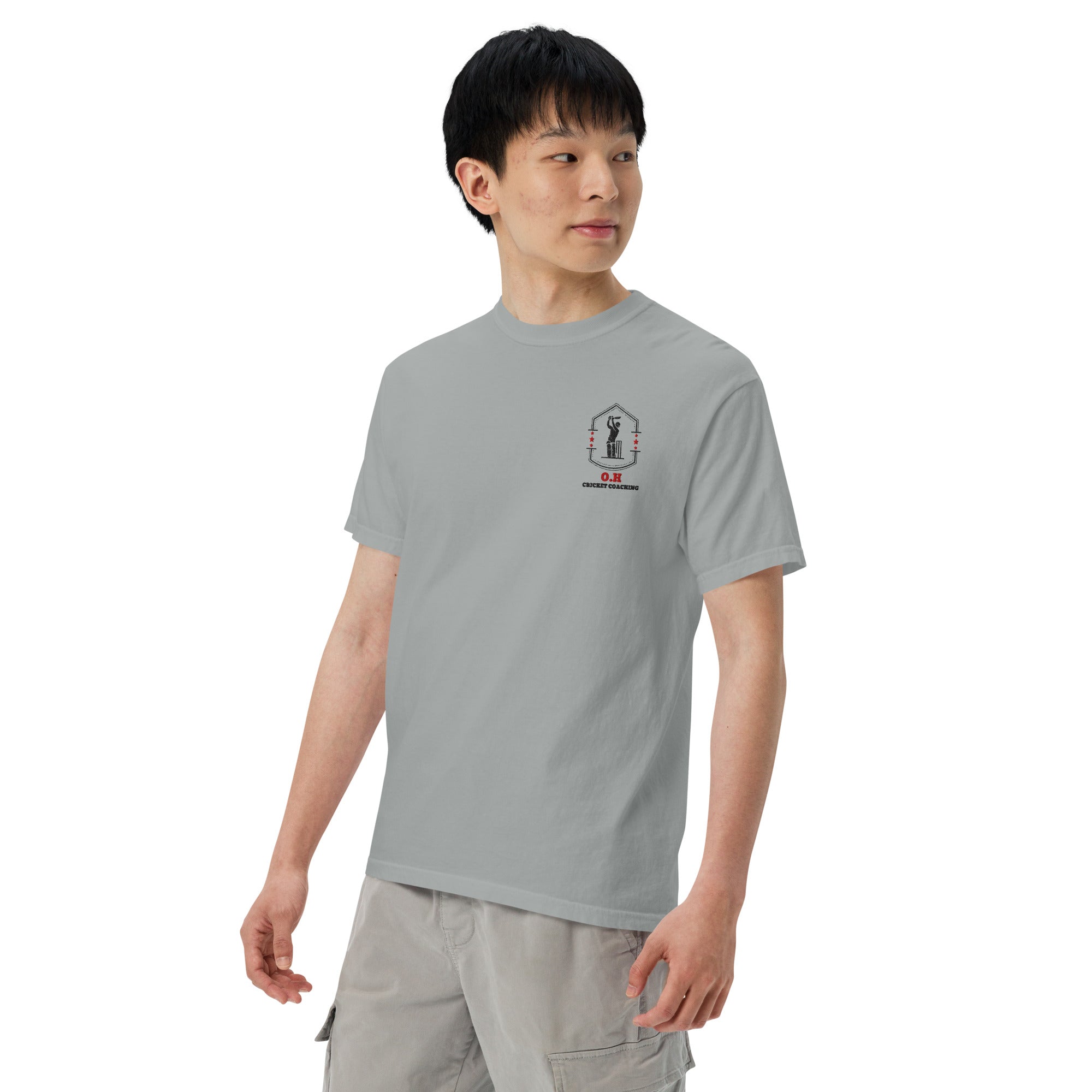 Person wearing a gray t-shirt with a logo on a white background