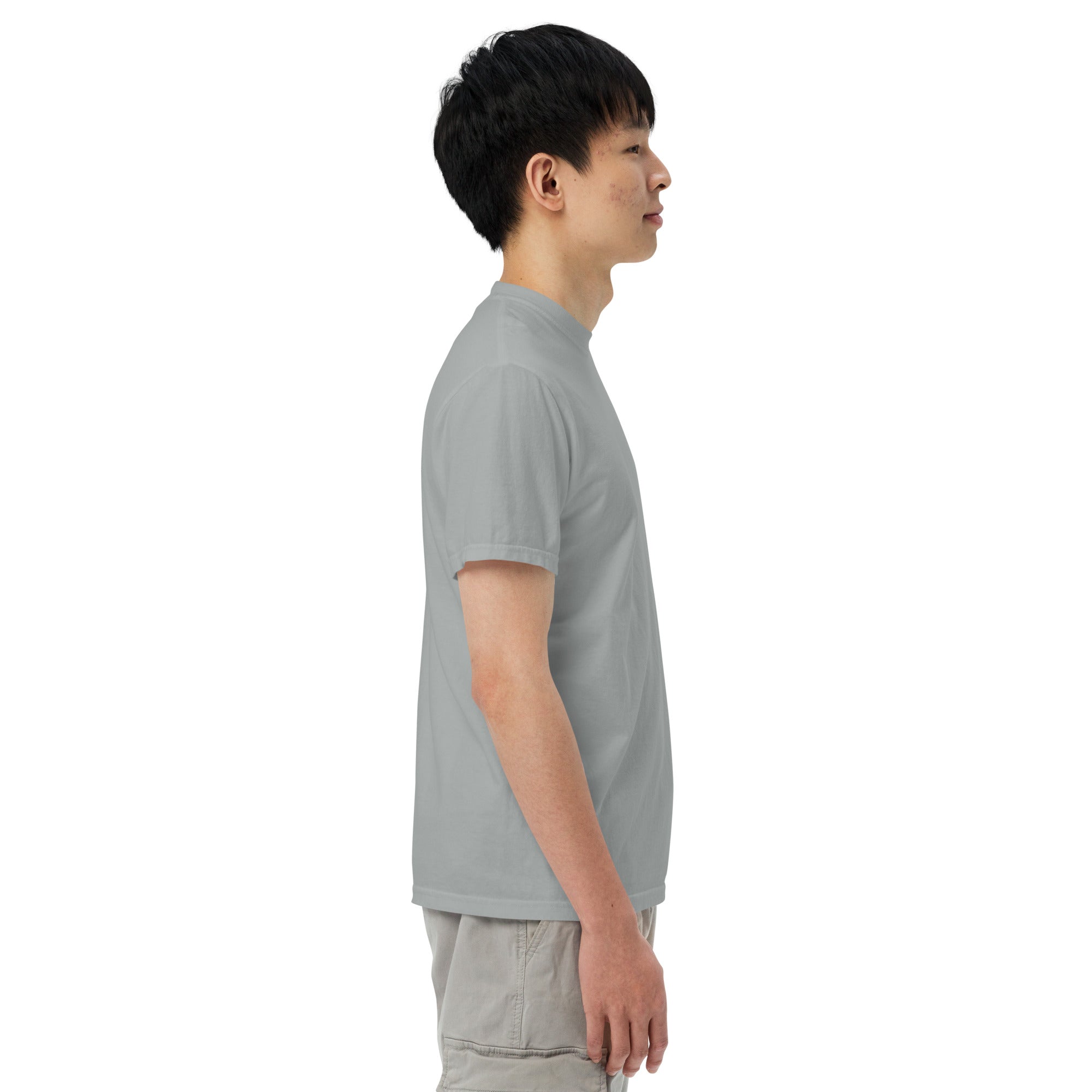 Person wearing a gray t-shirt and light-colored pants on a white background