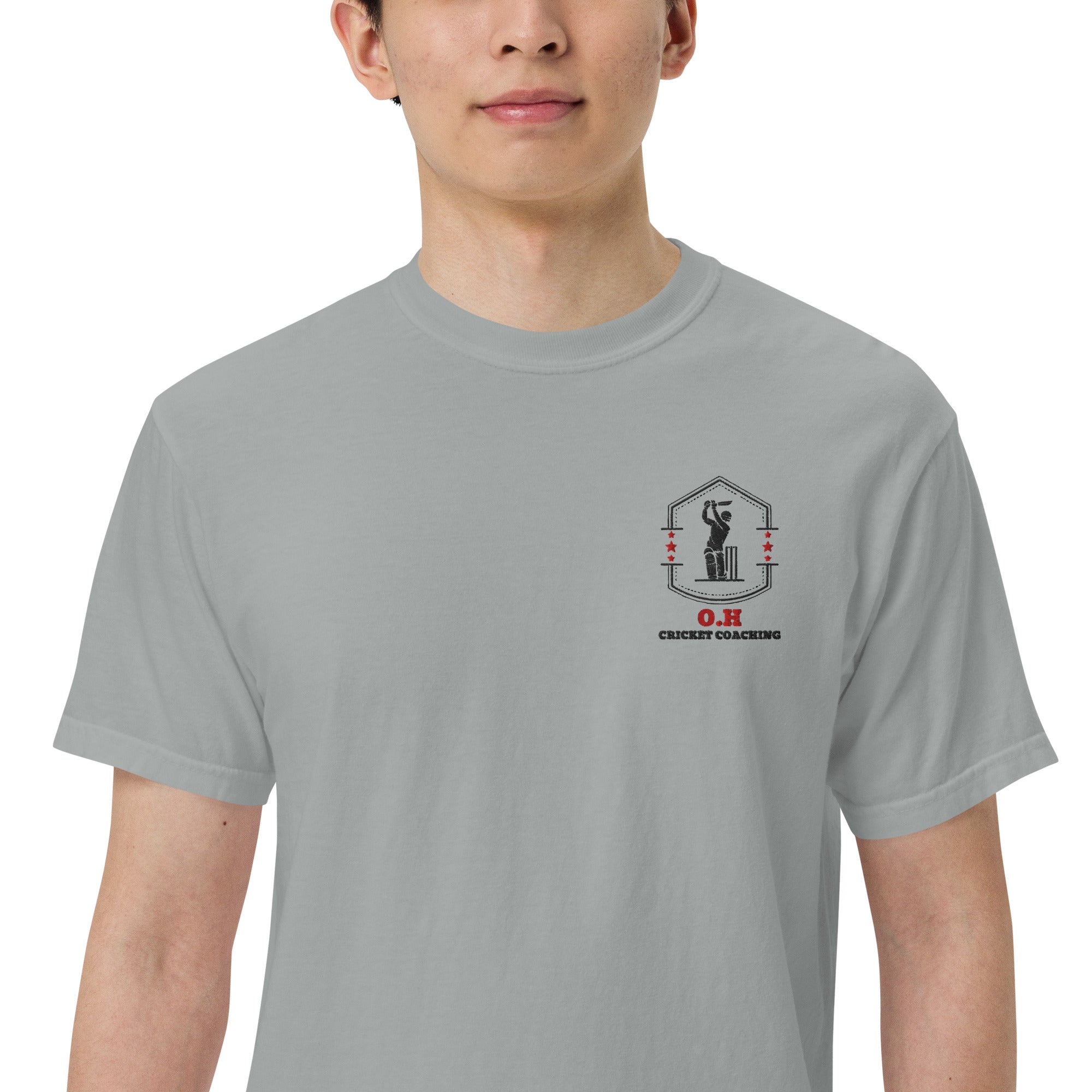 Person wearing a gray t-shirt with a logo and text on a white background