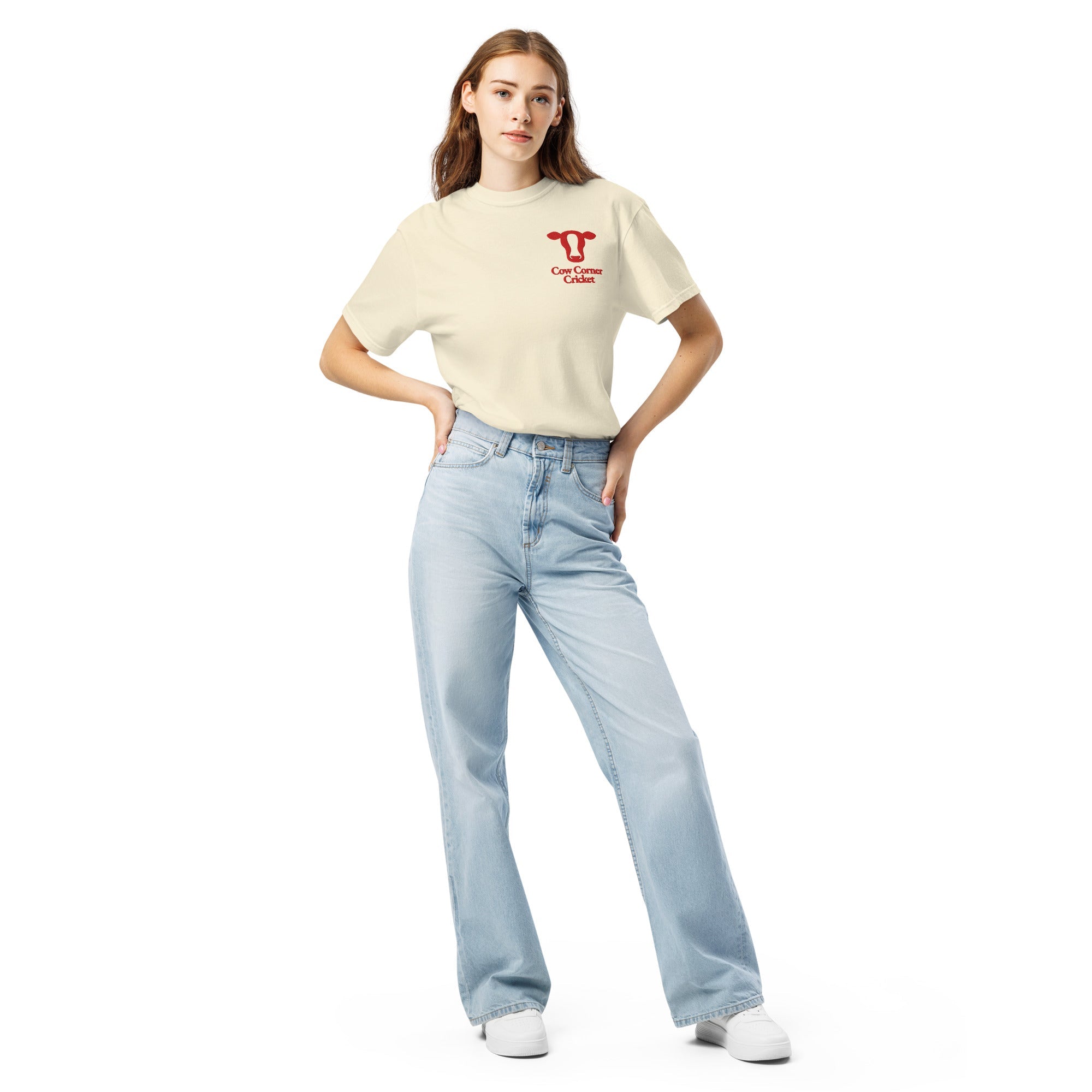 Woman wearing a beige t-shirt and light blue jeans on a white background