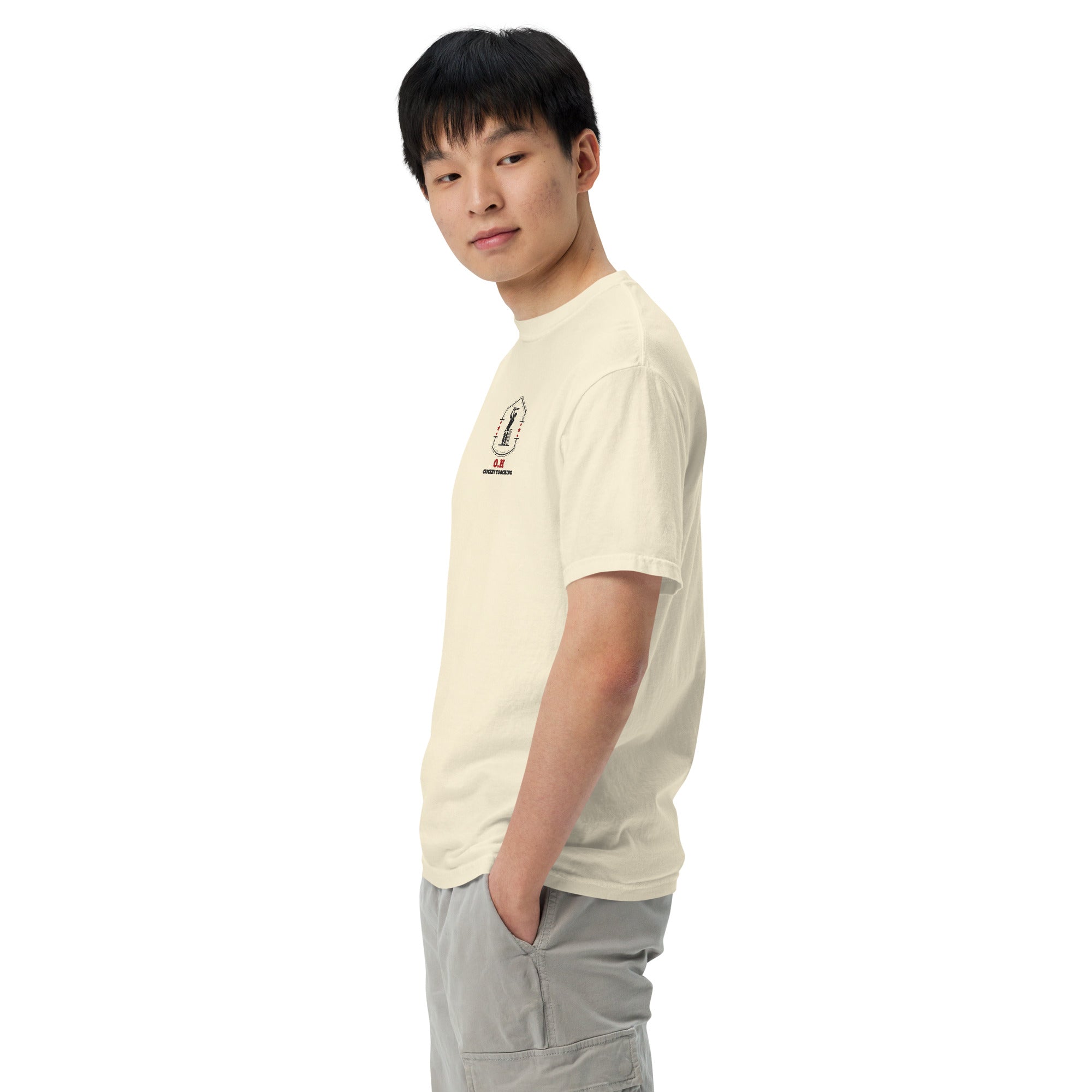 Person wearing a beige t-shirt with a logo on a white background