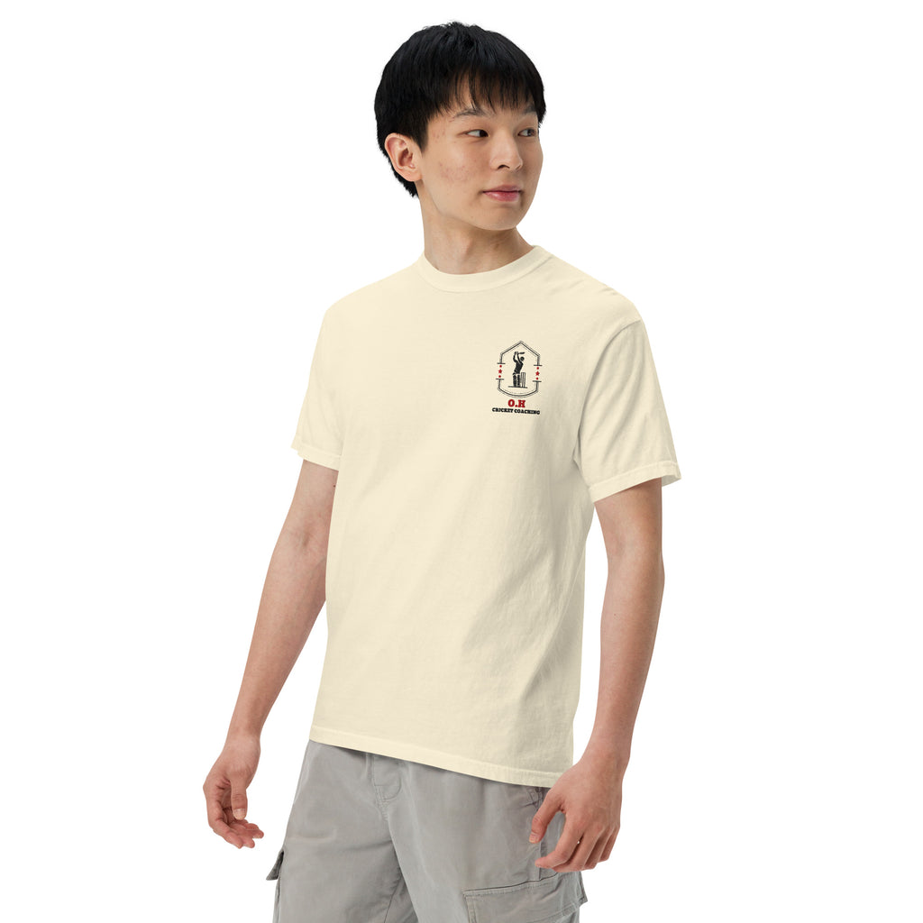 Person wearing a light-colored t-shirt with a small graphic on a white background