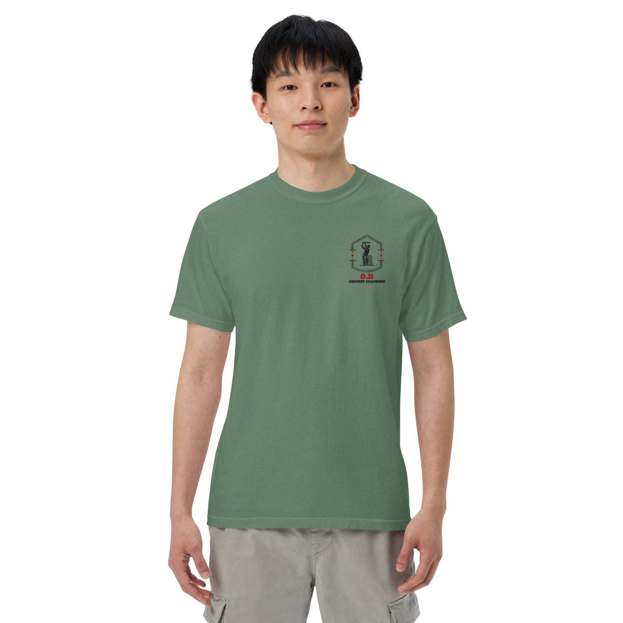 Person wearing a green t-shirt with a logo on a white background