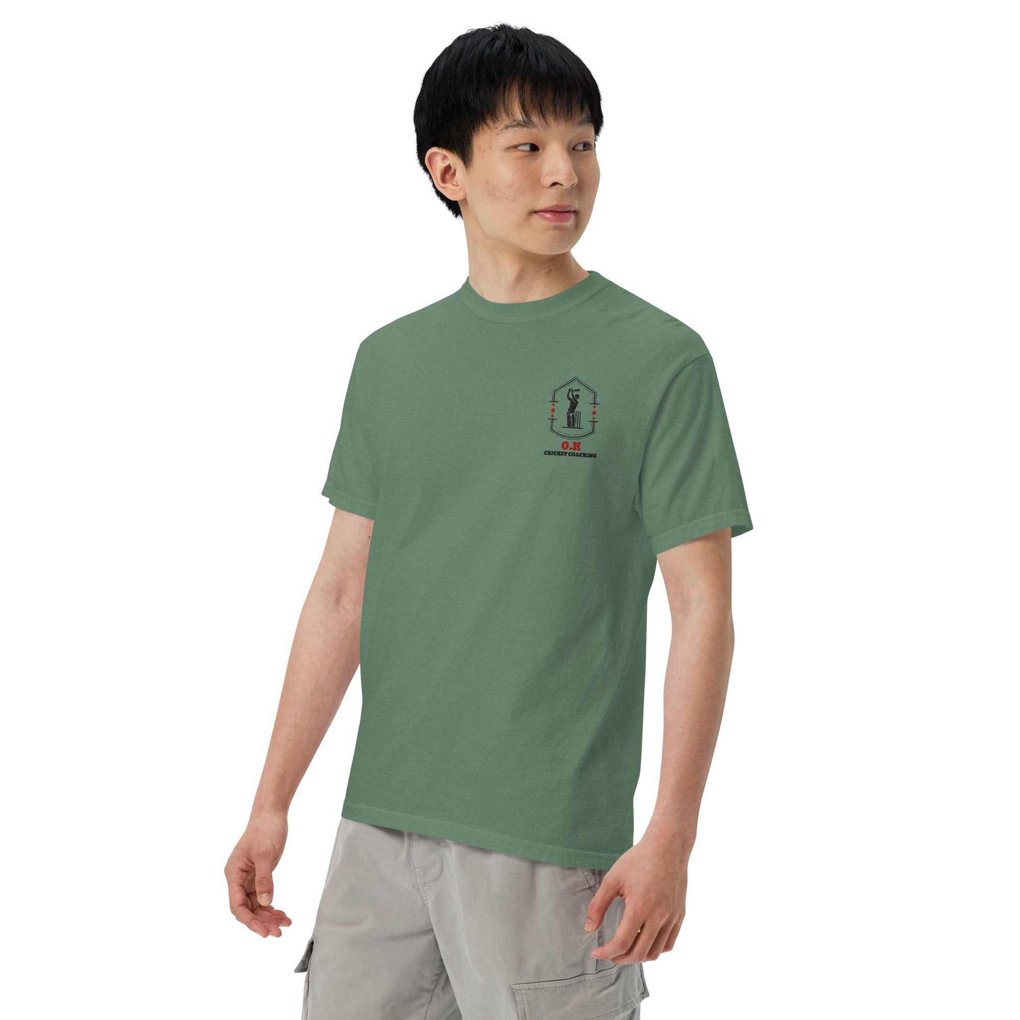 Person wearing a green t-shirt with a logo on a white background