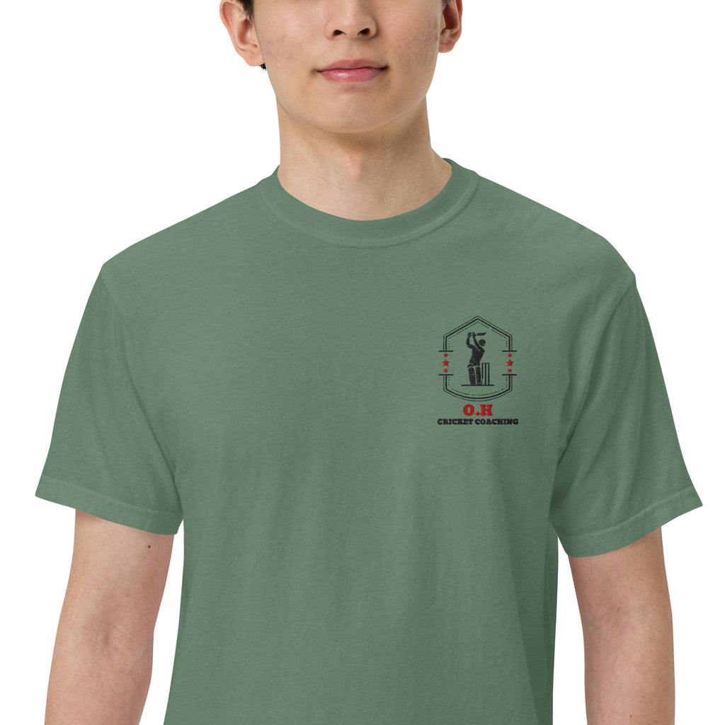Person wearing a green t-shirt with a logo on a white background
