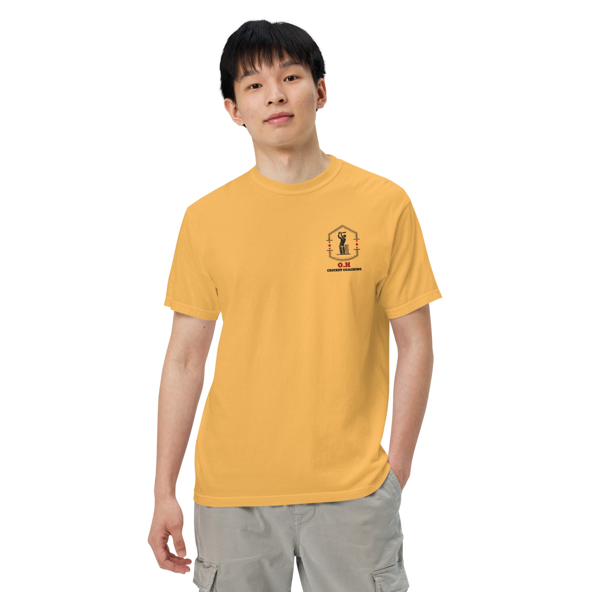 Person wearing a mustard yellow t-shirt with 'Dink Supply' logo on a white background