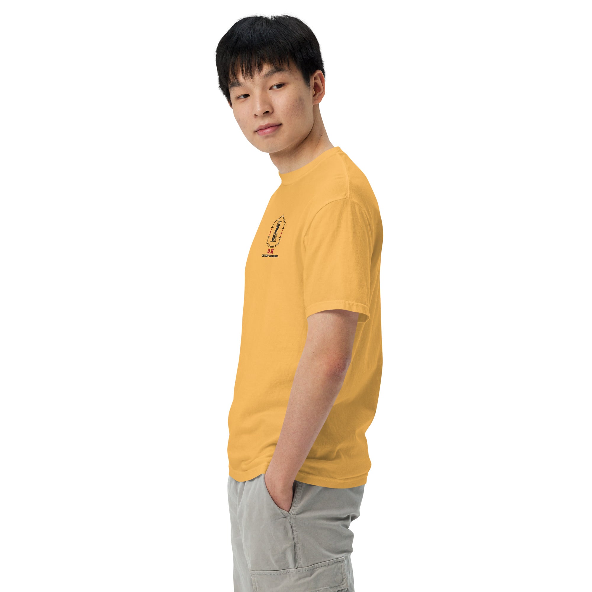 Person wearing a yellow t-shirt with a graphic design on a white background