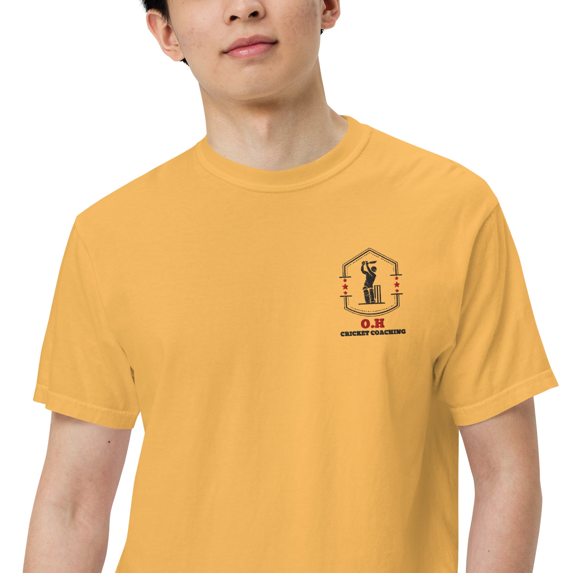 Person wearing a yellow t-shirt with a logo on the chest