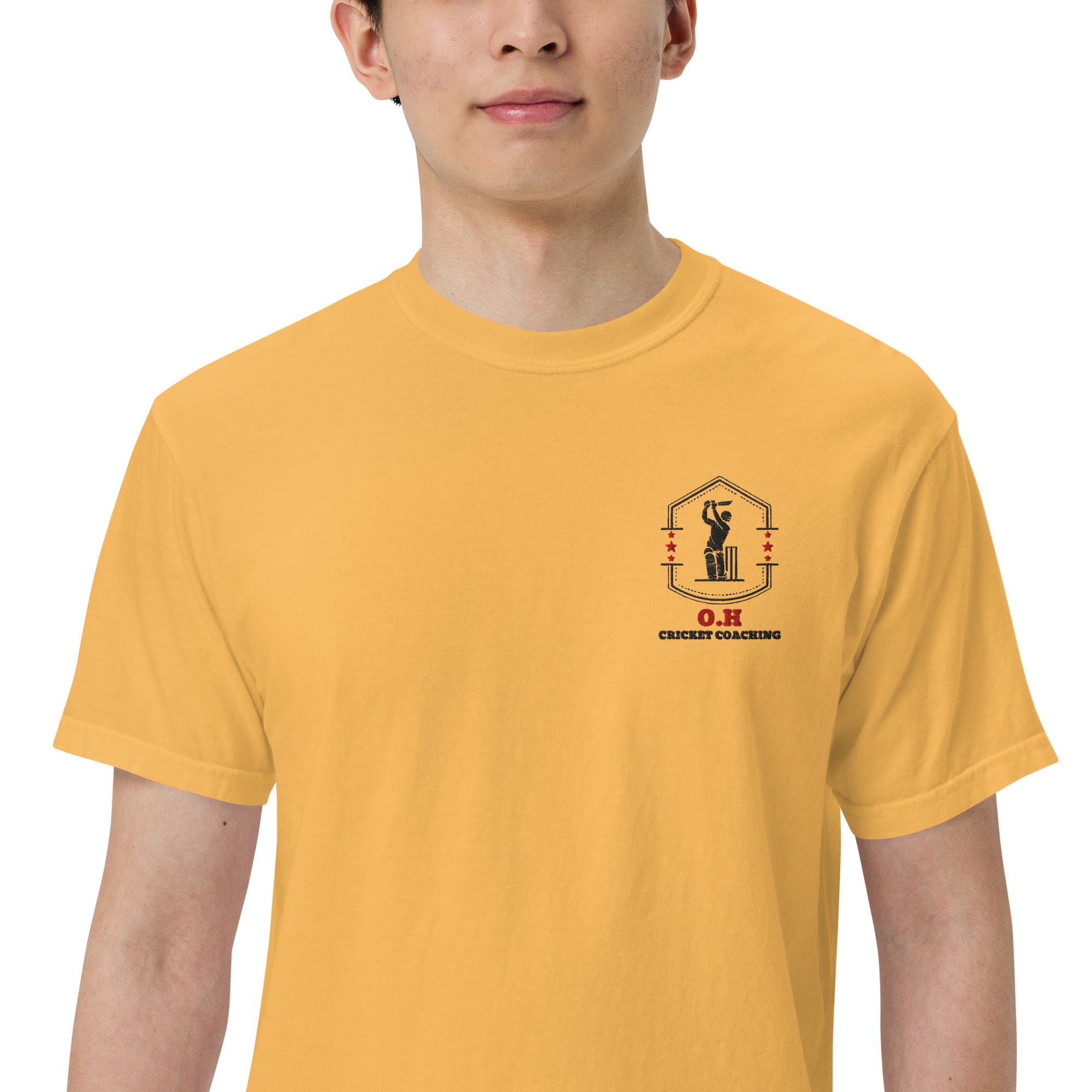 Person wearing a mustard yellow t-shirt with OH cricket cricket coaching logo 