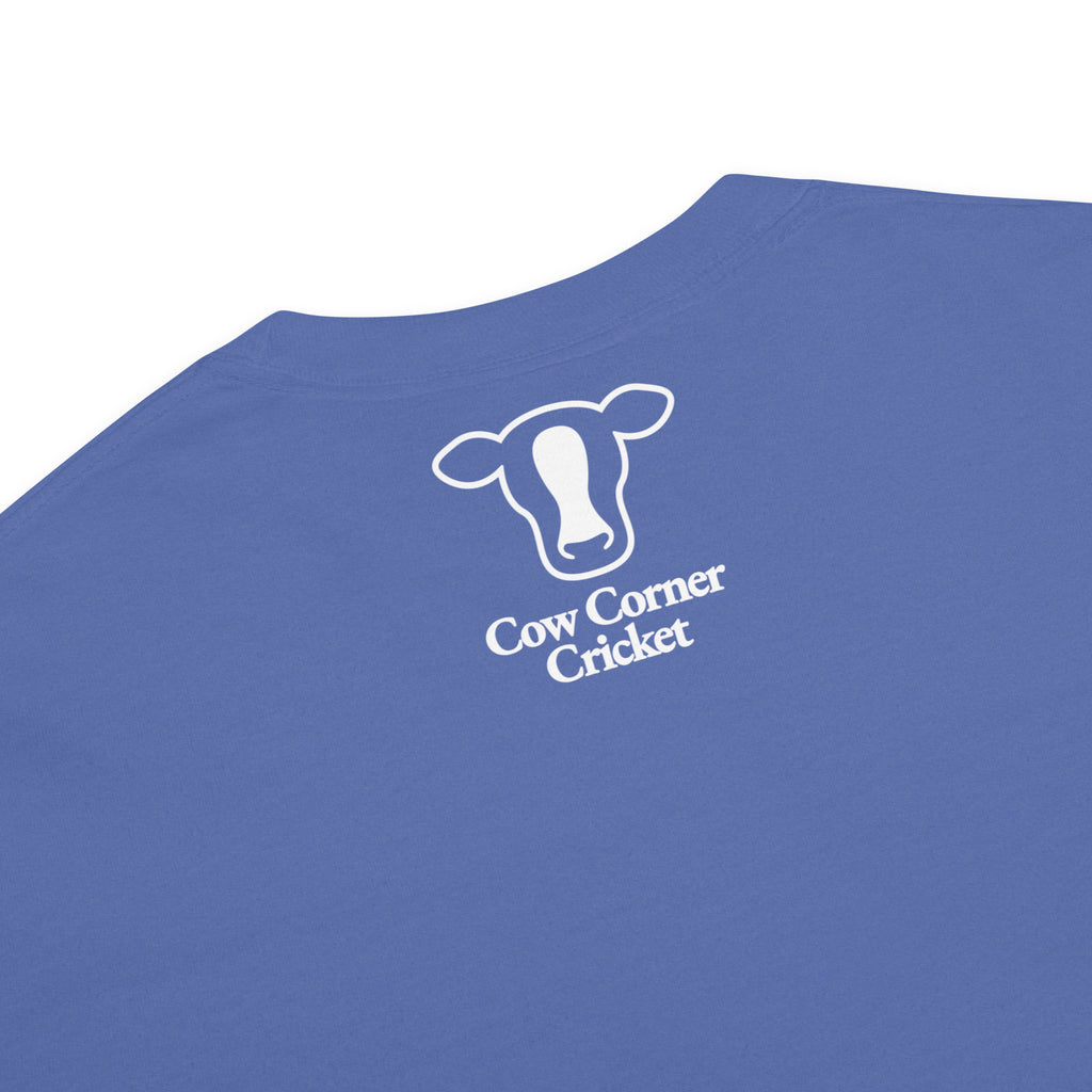 Blue short-sleeve t-shirt, printed with a white outline of a cow head and the text Cow Corner Cricket.