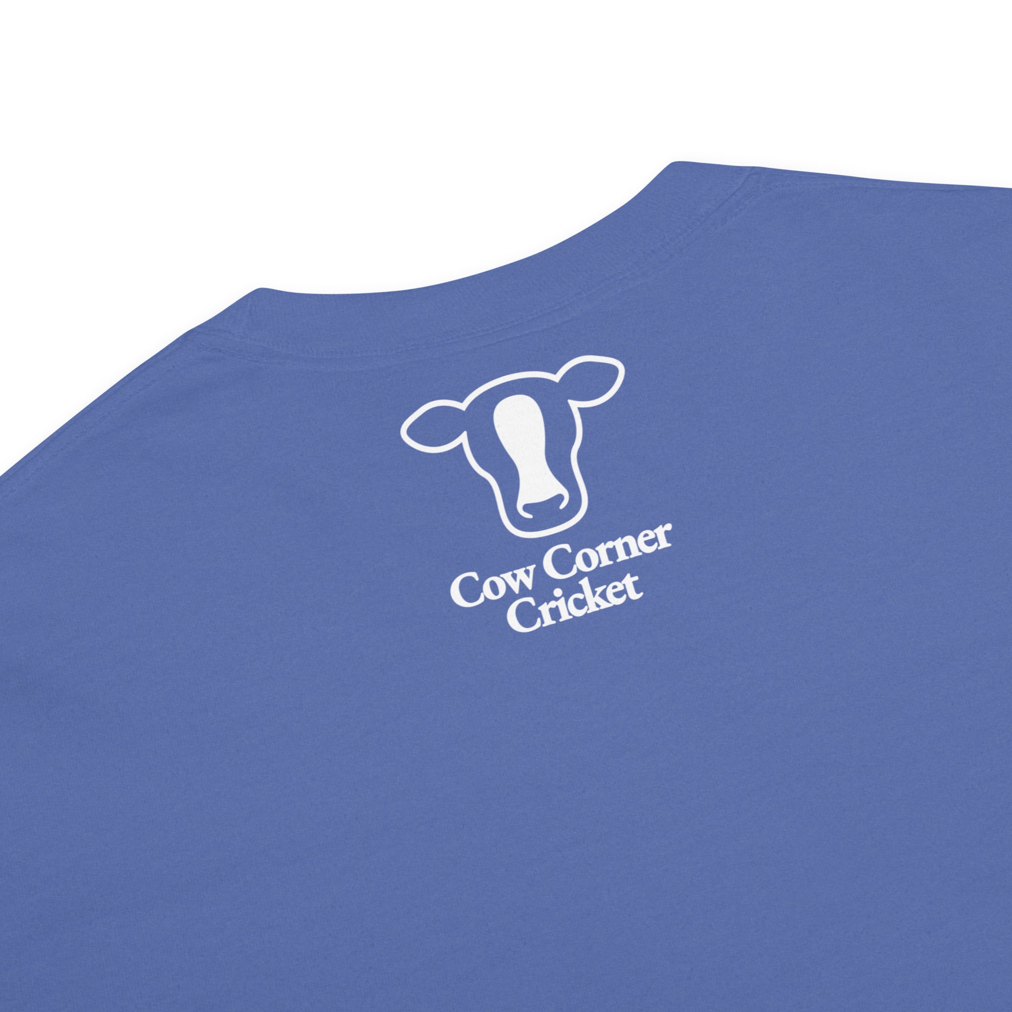Blue short-sleeve t-shirt, printed with a white outline of a cow head and the text Cow Corner Cricket.