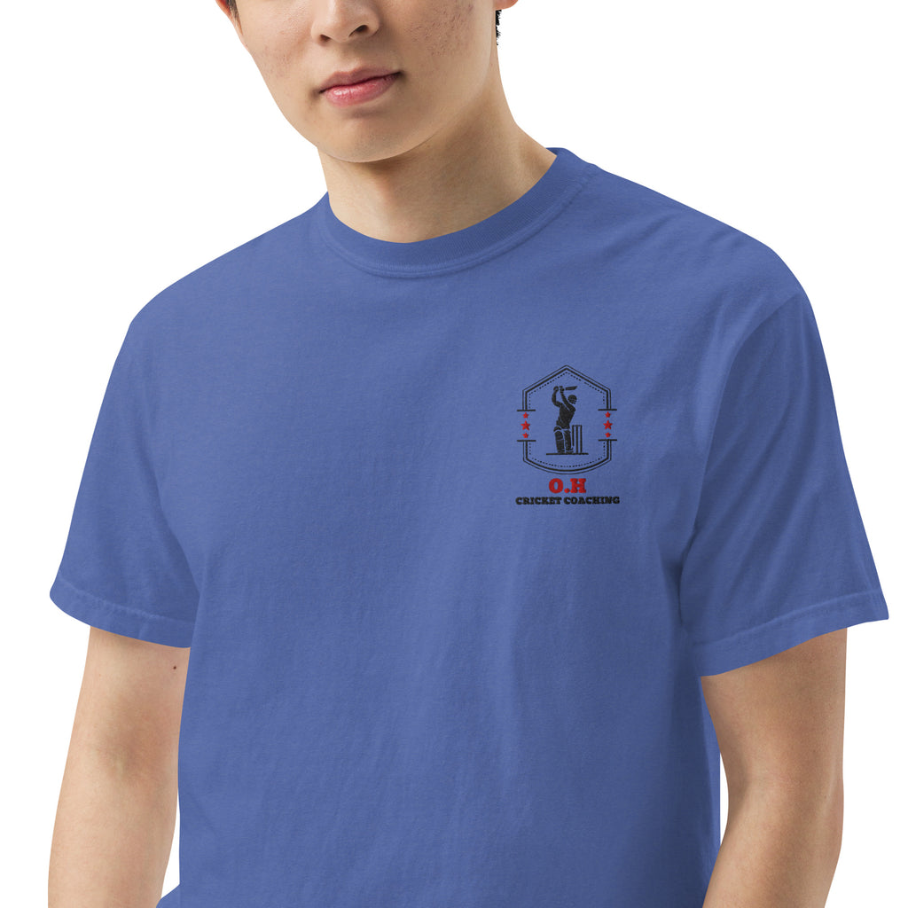 Person wearing a blue t-shirt with a logo on the chest