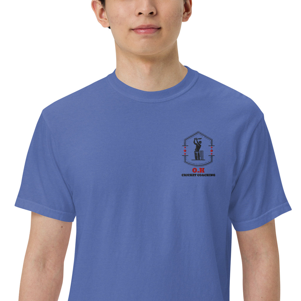 Person wearing a blue t-shirt with a logo on the chest against a white background