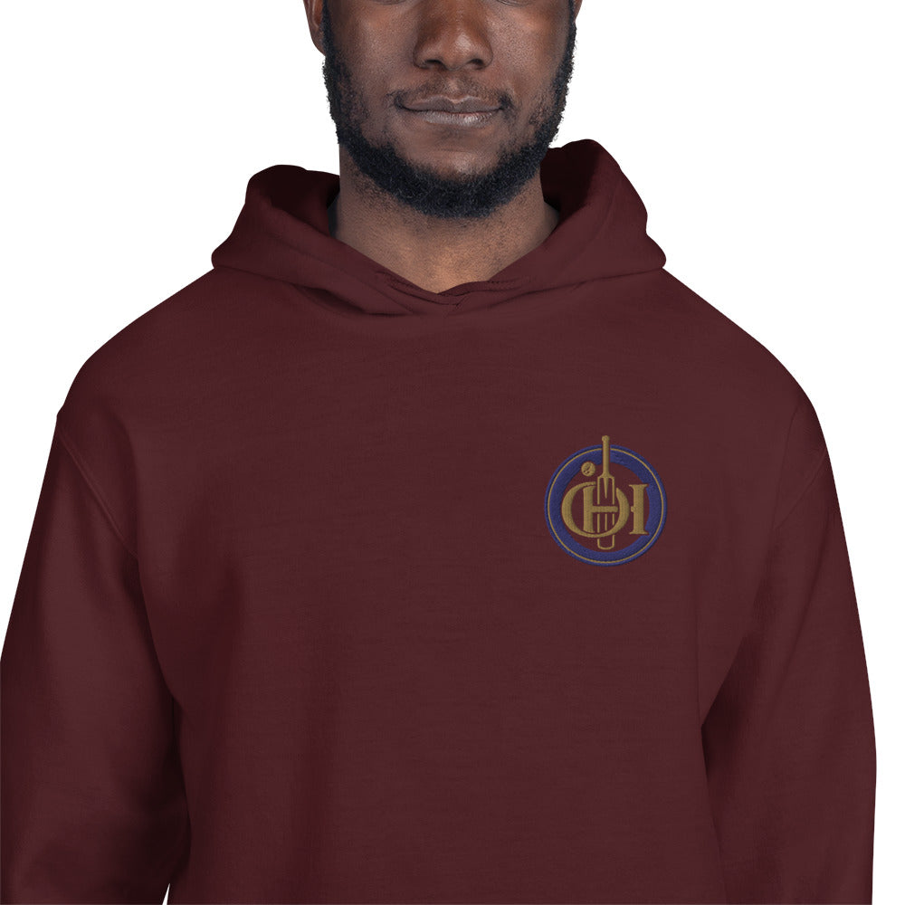 A man wearing a maroon pullover hoodie with a circular chest graphic.