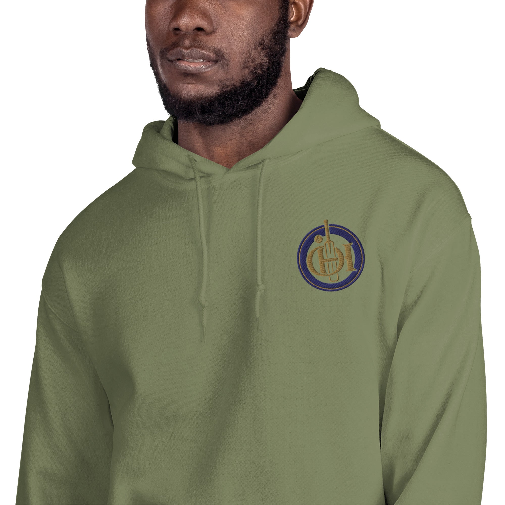 A man wearing green pullover hoodie with a circular embroidered logo on the left chest.