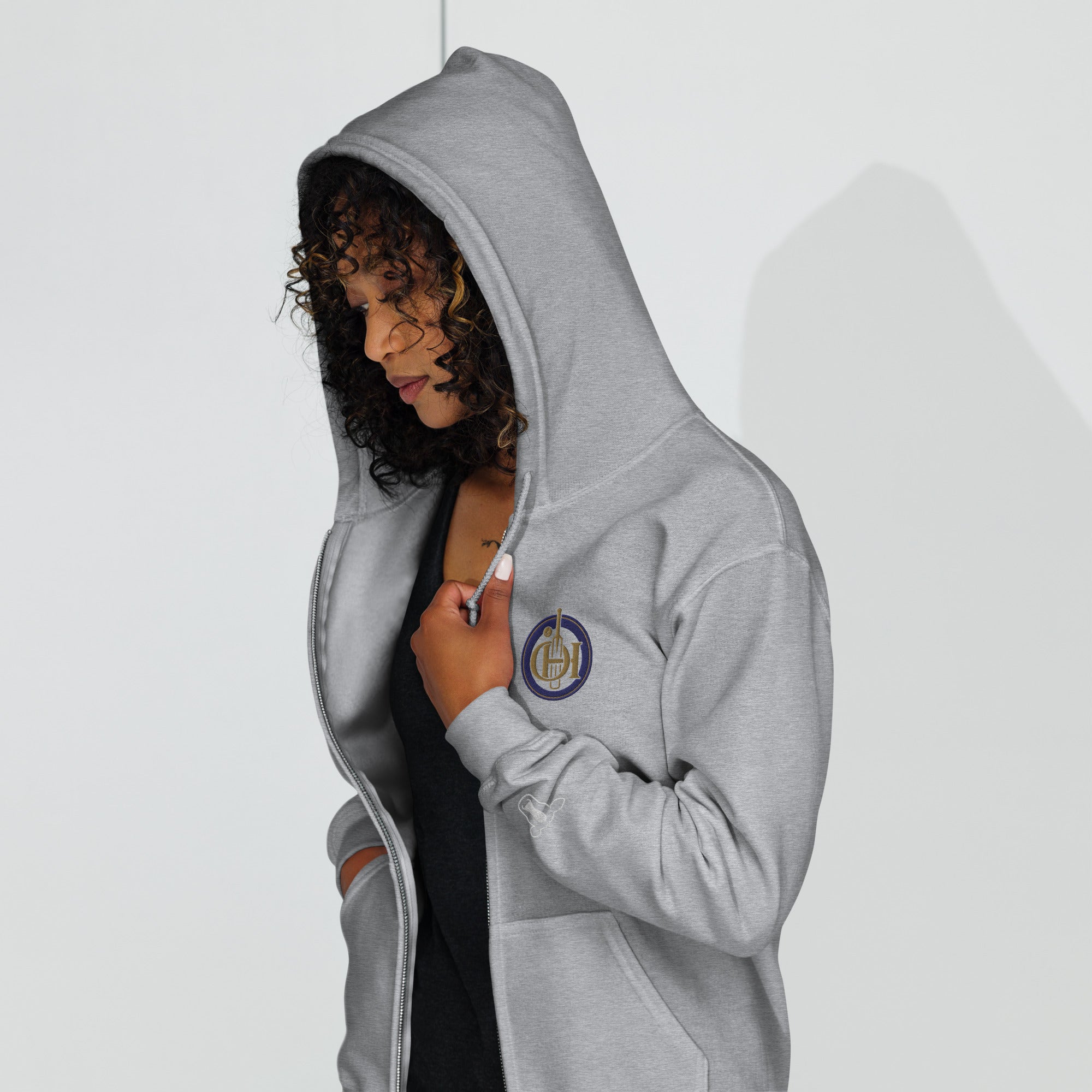 Person wearing a gray hoodie with a white background
